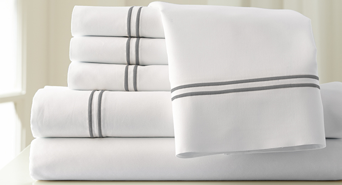 Best Bed Sheets For Learn What To And Avoid Pile Of Folded White Bed Linens
